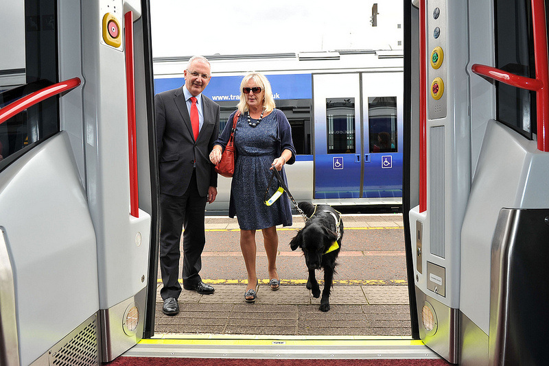 blind lady and dog entering a  train